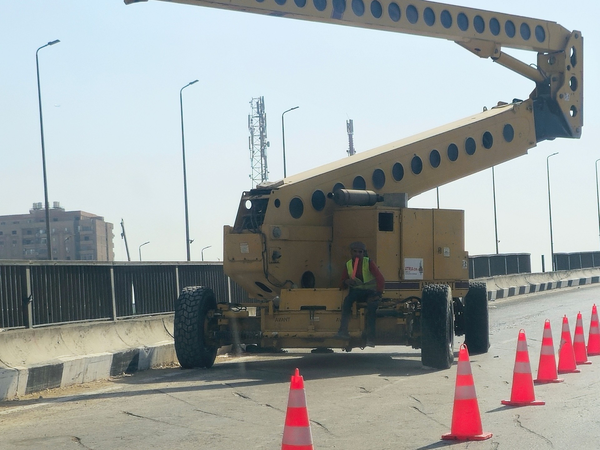 a construction truck at a construction site of a new bridge crossing over the ring road, new developments and road enhancements